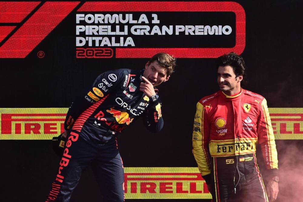 First placed Red Bull Racing's Dutch driver Max Verstappen (L) and Ferrari's Spanish driver Carlos Sainz Jr celebrate on the podium after the Italian Formula One Grand Prix race at Autodromo Nazionale Monza circuit, in Monza on September 3, 2023. - Photo by AFP