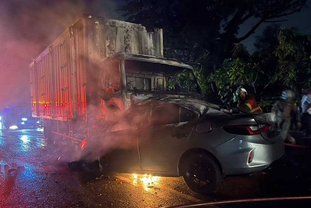 The vehicle caught fire after crashing into a container lorry at Kuala Garing, Rawang on Thursday.