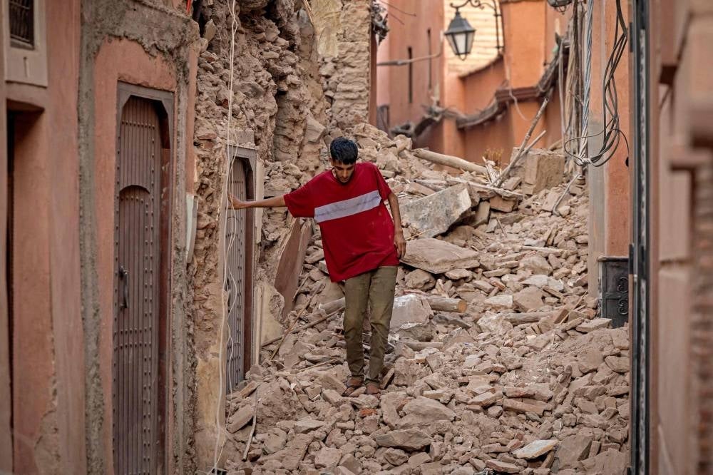 A resident navigates through the rubble following a 6.8-magnitude quake in Marrakesh on Sept 9, 2023. - Photo by Fadel Senna / AFP