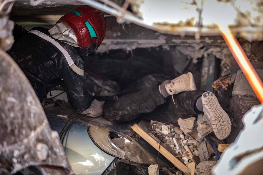 Rescuers search for survivors under the rubble of a collapsed house in Moulay Brahim, Al Haouz province, on September 9, 2023, after an earthquake. Photo by Fadel Senna/AFP