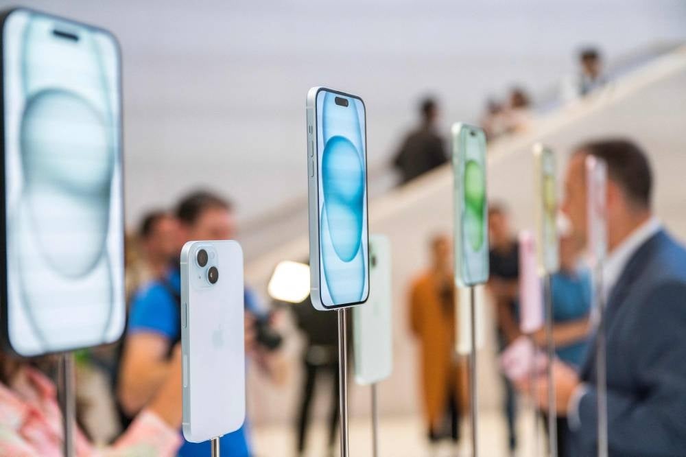 The new Apple iPhone 15, with EU ordered USB-C charger, is displayed amongst other new products during a launch event at Apple Park in Cupertino, California - AFP 