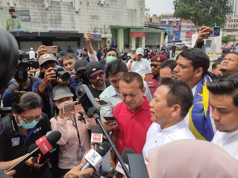 Tun Faisal (in white) in a press conference at the Dang Wangi IPD.