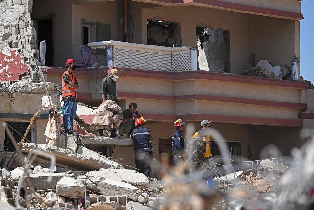 Members of the Emirati Rescue Team assist in relief work in Libya's eastern city of Derna on Sept 16 in the aftermath of flash flooding. (Photo by Karim SAHIB / AFP)