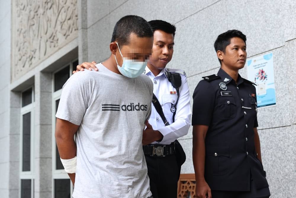 The trailer driver (left) who was involved in a collision involving more than a dozen vehicles at KM5.7 Jalan Persiaran Utara towards Puchong here yesterday was remanded for four days starting today. - BERNAMA
