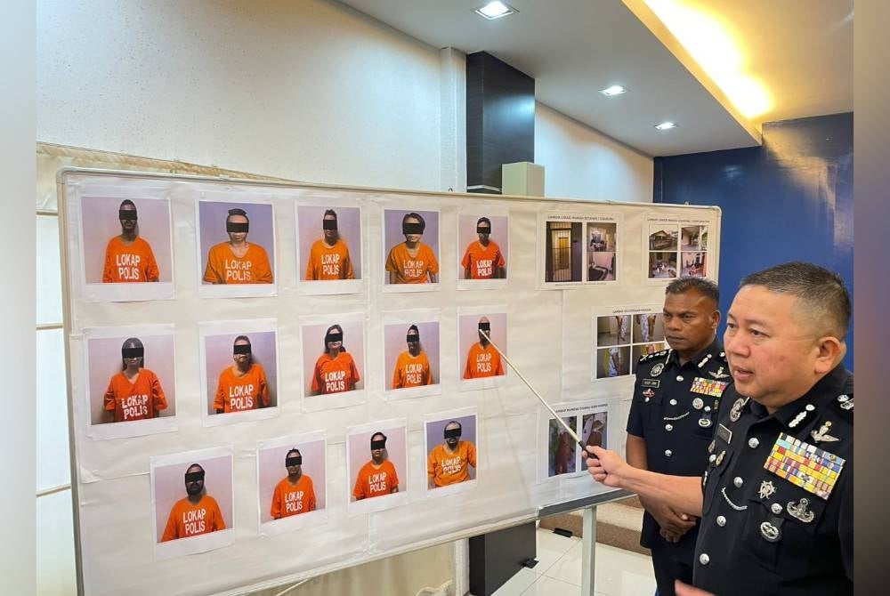 Kok Chin showing pictures of arrested suspects.