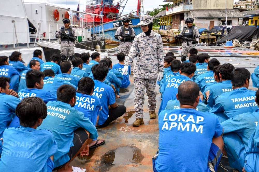 Kelantan MMEA deputy director (operations) Maritime Commander Khairun Dalilah Baharun carrying out inspection on the 43 Vietnamese fishermen, today. - Photo by Bernama