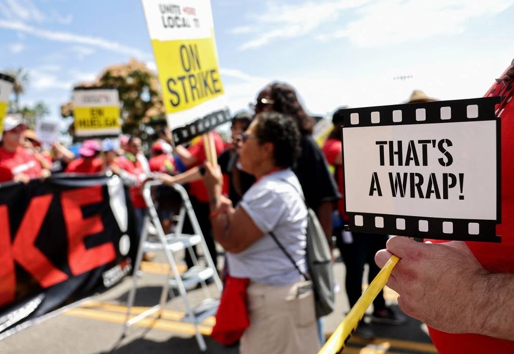 Striking W Hollywood Hotel workers from Unite Here Local 11 join the SAG-AFTRA and WGA (Writers Guild of America) picket line outside Netflix offices, in a show of union solidarity, on July 21, 2023 in Los Angeles, California. Members of SAG-AFTRA, Hollywood's largest union which represents actors and other media professionals, have joined striking WGA (Writers Guild of America) workers in the first joint walkout against the studios since 1960. (Photo by MARIO TAMA / AFP)