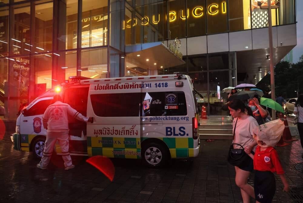 TOPSHOT - An ambulance is seen outside Siam Paragon shopping centre in Bangkok on Oct 3, following a shooting incident in the mall. (Photo by Jack TAYLOR / AFP)