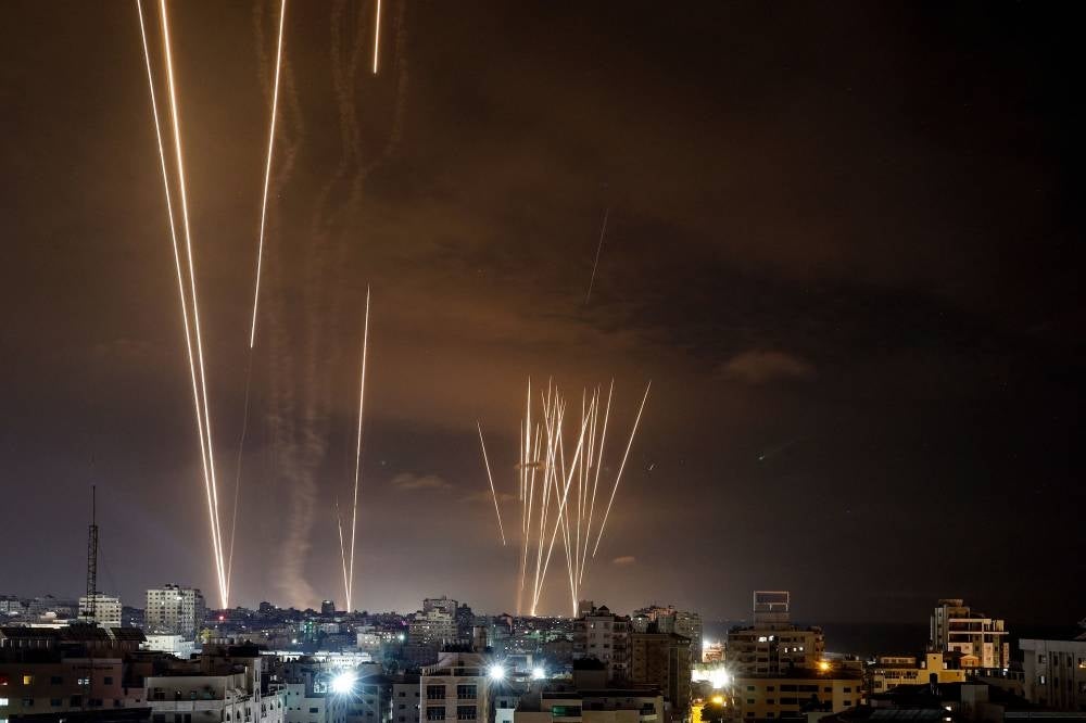A salvo of rockets is fired by Palestinian militants from Gaza City toward Israel on Oct 7. - Photo by AFP