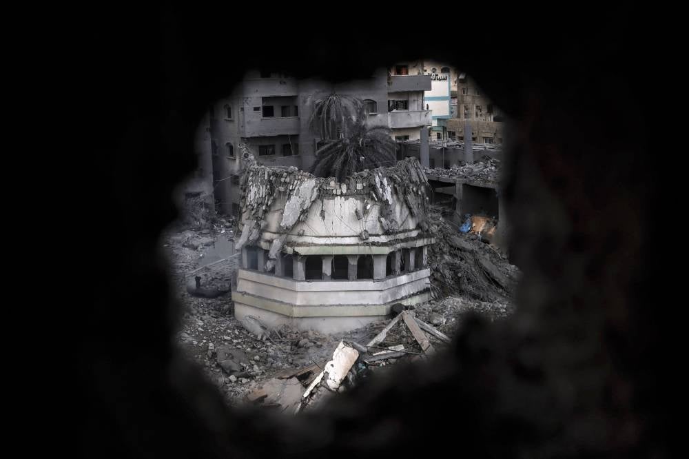 Palestinians inspect the destruction around Ahmed Yassin mosque, which was levelled by Israeli airstrikes, in Gaza City early on October 9, 2023. Photo by Mohammed Abed/AFP