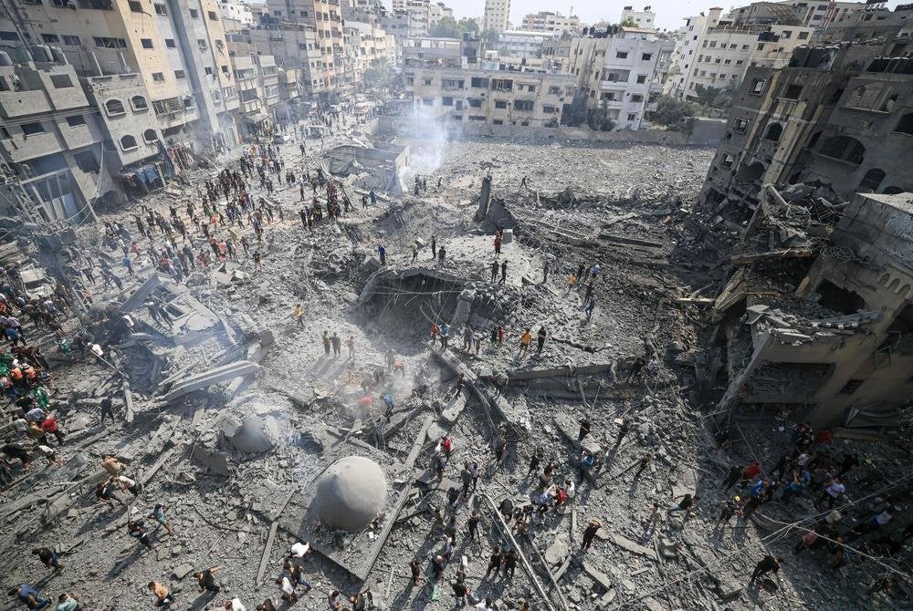 Palestinians inspect the damage following an Israeli airstrike on the Sousi mosque in Gaza City on Oct 9. (Photo by Mahmud HAMS / AFP)