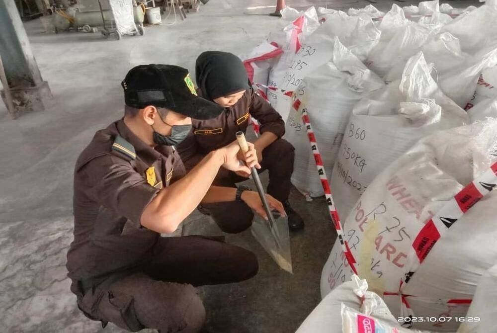 Padi and Beras Regulatory Body officers conducting checks at the factory.