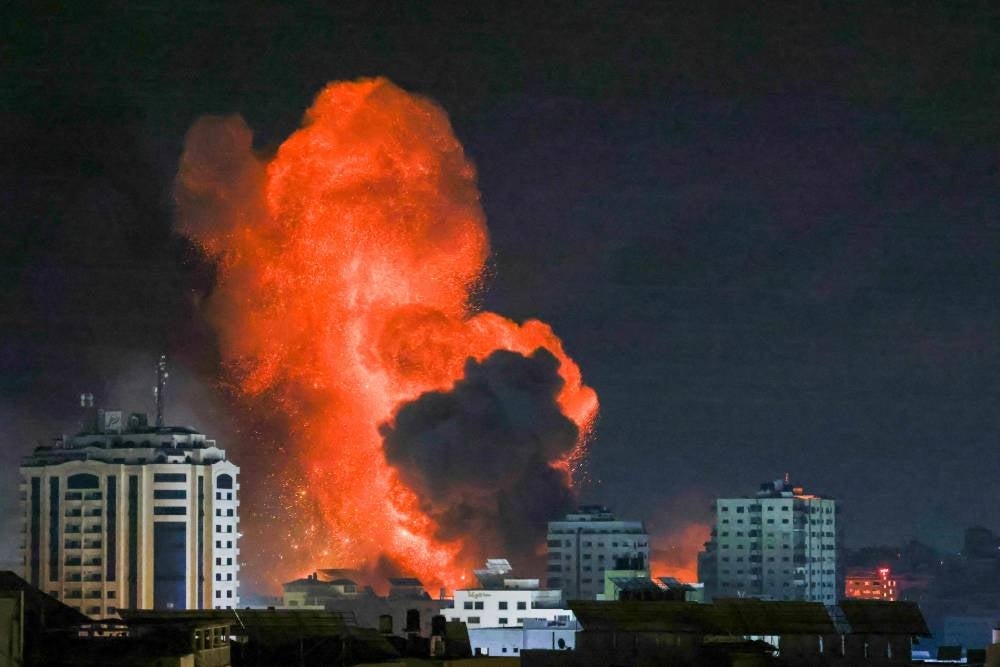 TOPSHOT - A fireball erupts from an Israeli airstrike in Gaza City on October 9, 2023. - AFP