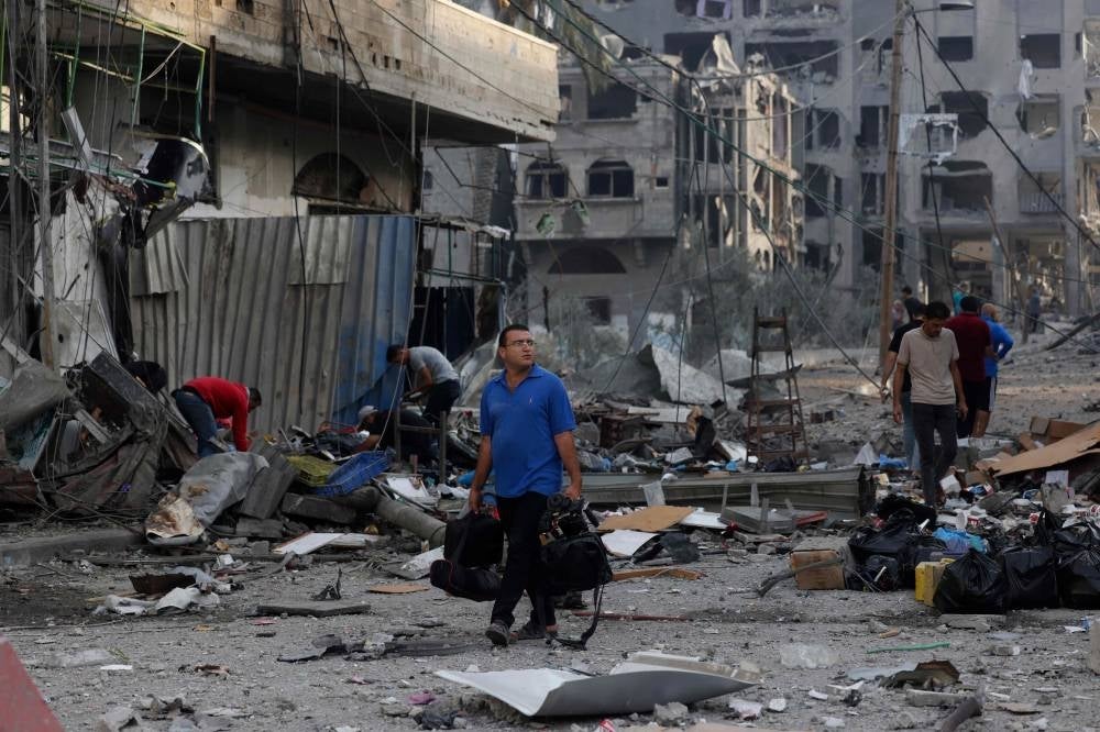 Palestinians leave their homes to safer areas in Gaza City on October 11, 2023, on the fifth day of battles between Israel and the Hamas movement - FILE PIX 