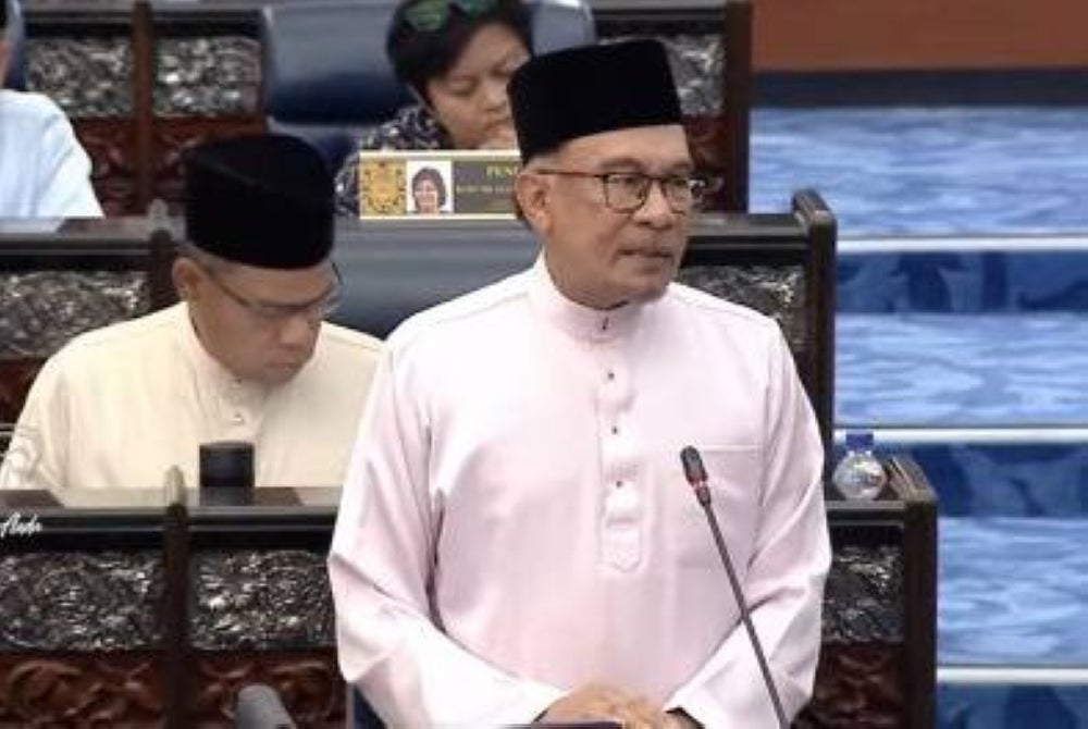Finance Minister and Prime Minister Datuk Seri Anwar Ibrahim tabling the 2024 Budget at the Dewan Rakyat, today.