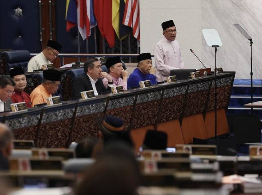 Finance Minister Datuk Seri Anwar Ibrahim tabling the Malaysia Madani Budget 2024 in Parliament, today. - Photo by Bernama