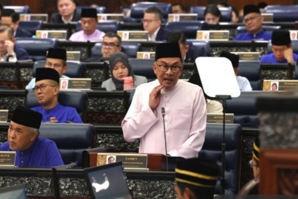 Finance Minister Datuk Seri Anwar Ibrahim tabling the Malaysia Madani Budget 2024 in Parliament, today. - Photo by Bernama