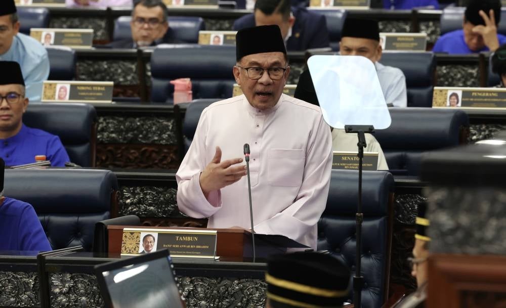 Finance Minister Datuk Seri Anwar Ibrahim tabling the Malaysia Madani Budget 2024 in Parliament, today. - Photo by Bernama