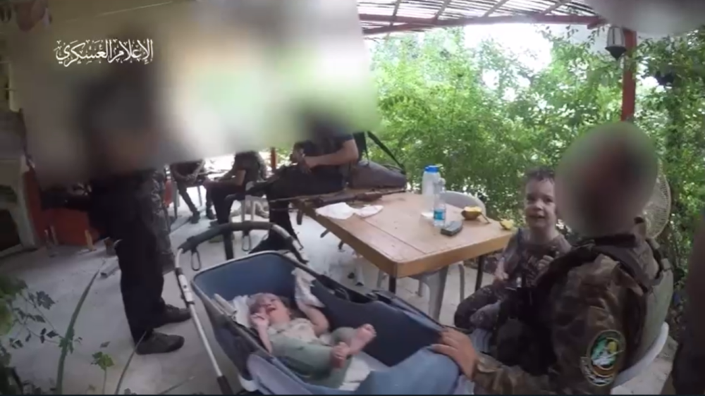Al-Qassam fighters gently rocking a baby's crib to soothe the infant