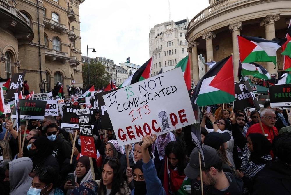 People gather with placards and Palestinian flags to take part in a 'March For Palestine', part of a pro-Palestinian national demonstration, in London on Oct 14, organised by Palestine Solidarity Campaign, Friends of Al-Aqsa, Stop the War Coalition, Muslim Association of Britain, Palestinian Forum in Britain and CND. (Photo by Adrian DENNIS / AFP)