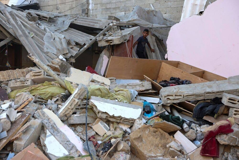 A Palestinian boy looks at the damage as he stands on the rubble following an Israeli military strike on the Rafah refugee camp, in the southern of Gaza Strip on Oct 15, amid the ongoing battles between Israel and Hamas - AFP