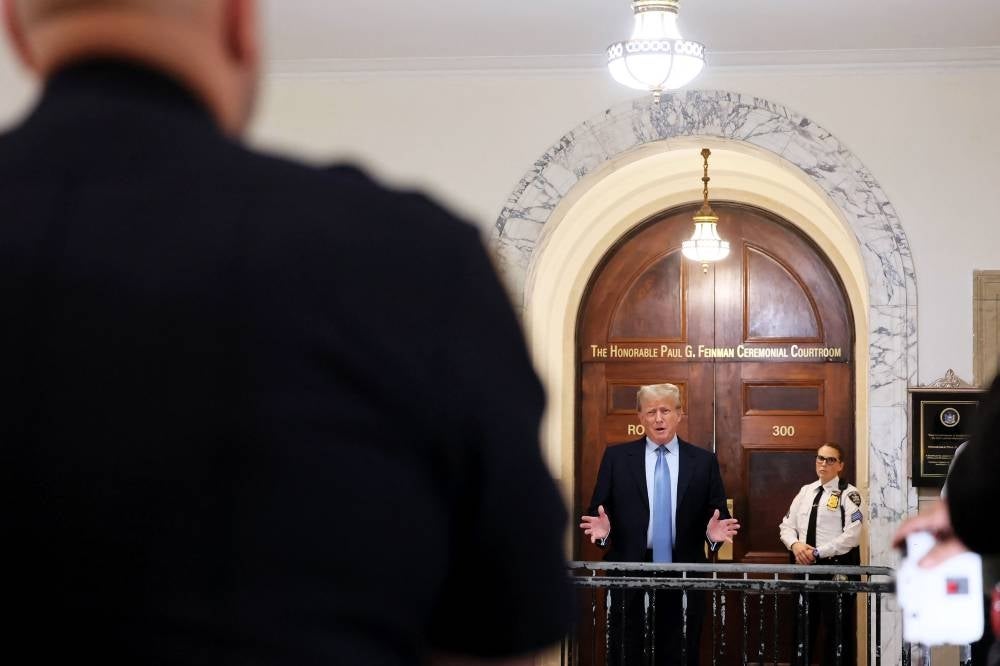 Former President Donald Trump speaks after returning from a break during his civil fraud trial at New York State Supreme Court on October 18, 2023 in New York City. - Photo by AFP