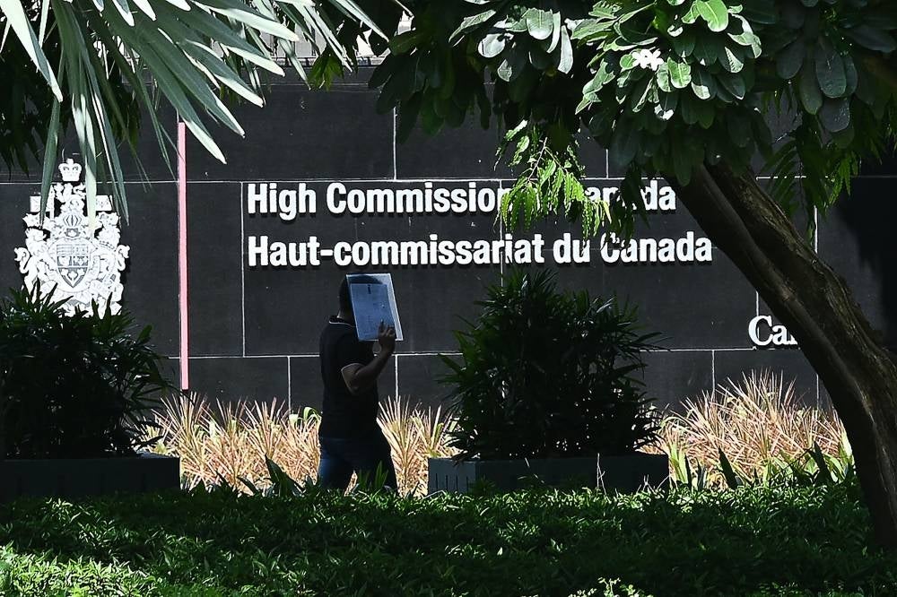 A man walks past the High Commission of Canada in New Delhi on September 19, 2023. A senior Canadian diplomat was ordered to leave India on September 19, New Delhi's foreign ministry said, hours after Ottawa expelled an Indian diplomat over the killing of a Sikh separatist near Vancouver. - Photo by AFP