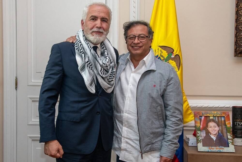 Handout photo released by Colombian Presidency showing President Gustavo Petro (R) posing with Palestine Ambassador to Colombia, Raouf Almalki, after meeting in Bogota on Oct 19 (Photo by Handout / Colombian Presidency / AFP) 
