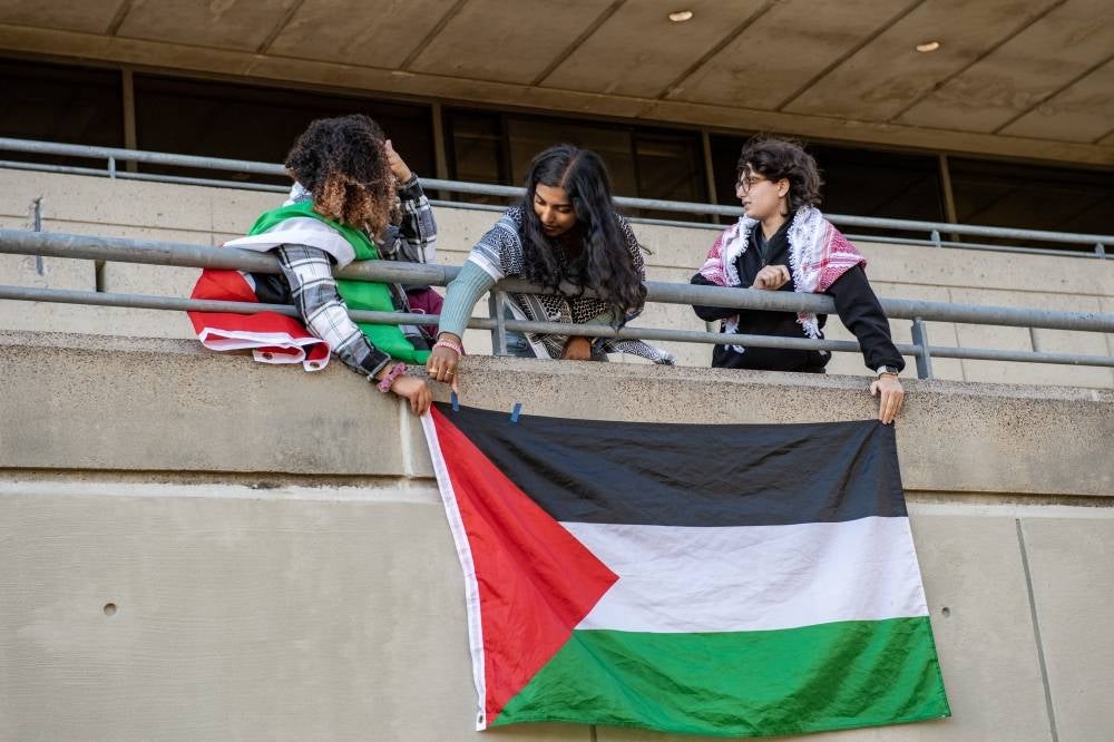Students hang a Flag of Palestine on the student centre wall at a rally to support Palestine at MIT (Massachusetts Institute of Technology) in Cambridge, Massachusetts on Oct 19, 2023. - Photo by AFP