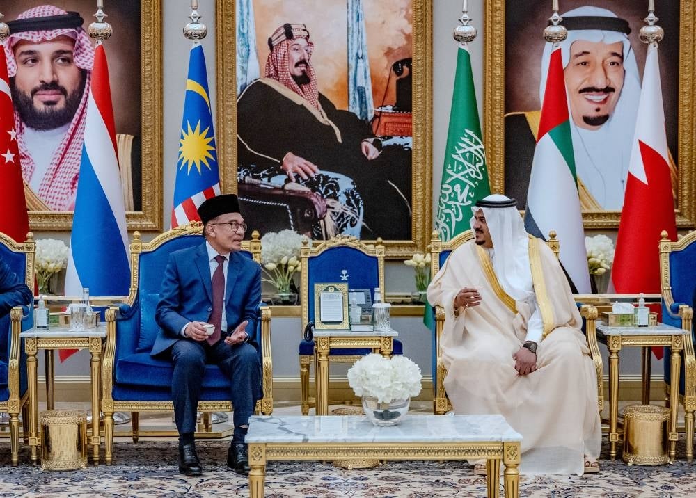 Prime Minister Datuk Seri Anwar Ibrahim welcomed by the Deputy Governor of Riyadh Region, Prince Mohammed bin Abdulrahman (right) after he arrived at King Khalid International Airport for the Asean and Gulf Cooperation Council (GCC) Summit, yesterday. - Photo by Bernama
