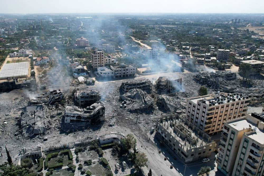 An arial view shows destroyed buildings in al-Zahra city south of Gaza City on Oct 20, 2023 following Israeli bombardment overnight. - (Photo by BELAL ALSABBAGH / AFP)