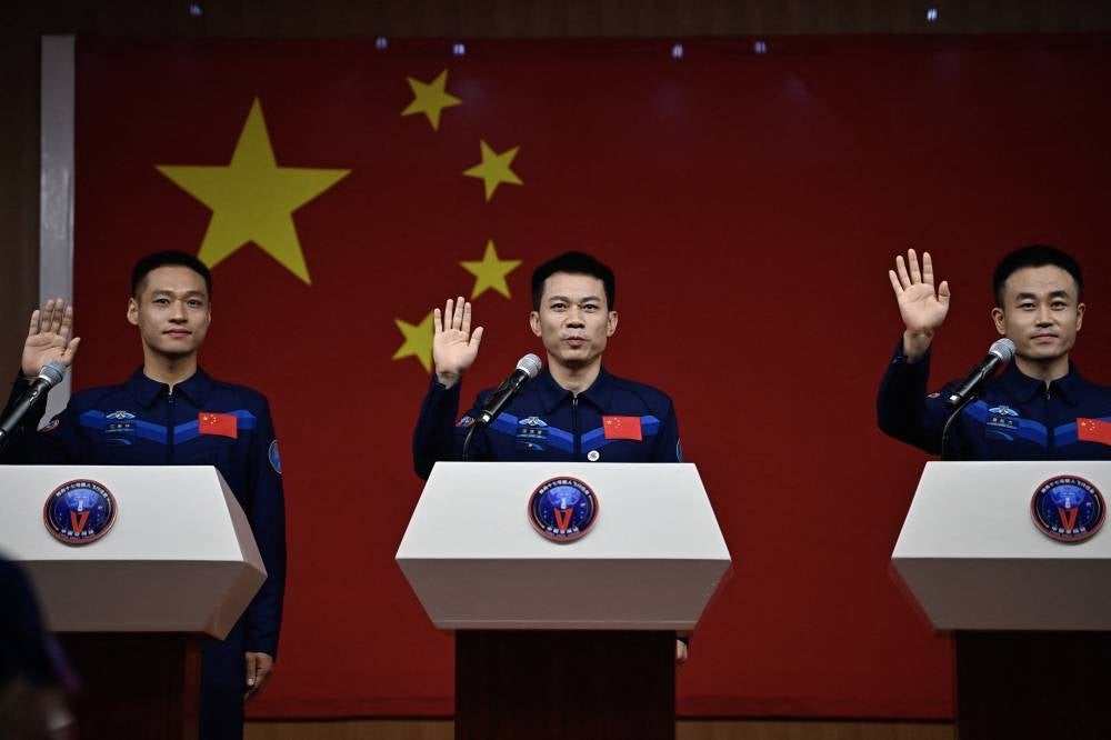 (L-R) Astronauts Jiang Xinlin, Tang Hongbo and Tang Shengjie attend a press conference at the Jiuquan Satellite Launch Centre in China's northwestern Gansu province on Oct 25, 2023. - (Photo by Pedro PARDO / AFP)