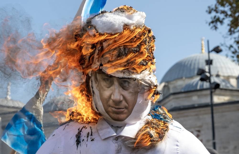 Protesters burn a puppet featuring Israeli Prime Minister Benjamin Netanyahu during a demonstration against Israel in Istanbul on Oct 20, 2023, after Turkey declared a three-day national mourning in solidarity with the Palestinian people. - (Photo by BULENT KILIC / AFP)