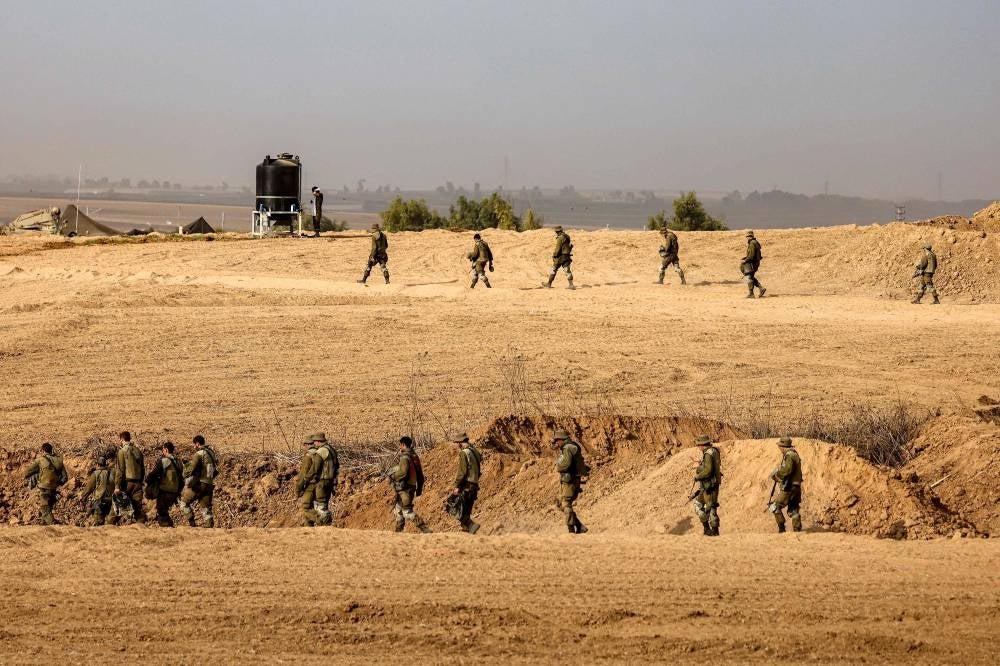 Israeli soldiers walk at a position along the border with the Gaza Strip near Sderot in southern Israel on October 27, 2023 amid ongoing battles between Israel and the Palestinian Hamas movement. Photo by Jack Guez/AFP