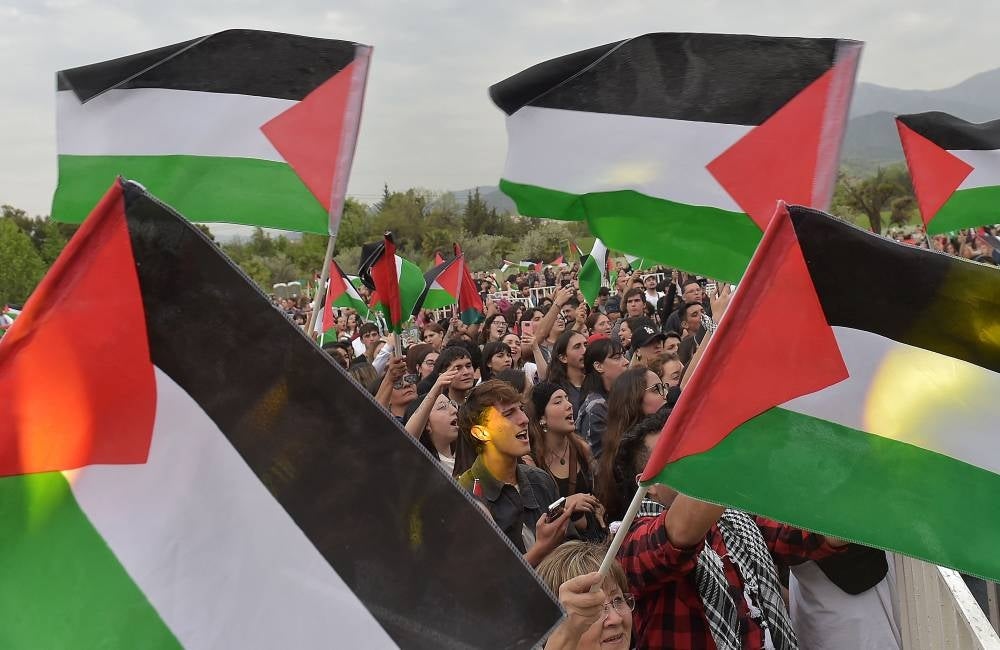 People display Palestinian flags during "Chile Sings Palestine Against all Violence", a festival with more than 20 national and international artists organized by the Palestinian community of Chile - AFP 