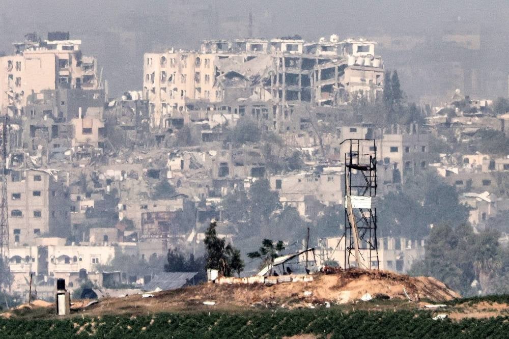 A view of a watchtower and heavily damaged buildings behind after Israeli bombardment amid ongoing battles between Israel and the Palestinian Hamas movement. Photo by Jack Guez/AFP