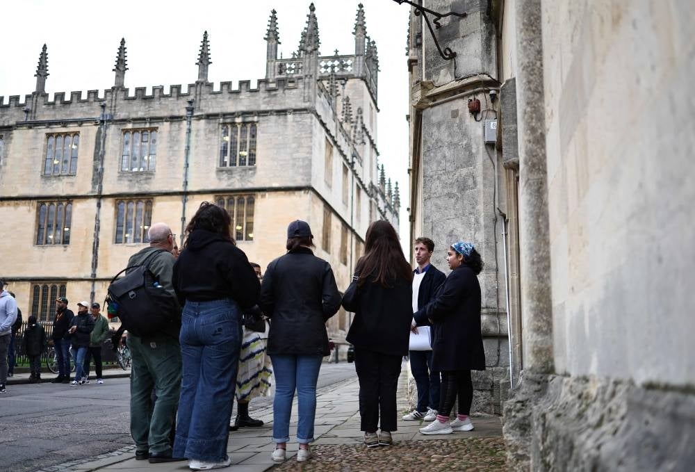 British universities Oxford and Cambridge are constantly ranked among the best in the world and celebrated for their academic excellence. But the murkier corners of their pasts are now being brought to life for tourists, as the country grapples with its problematic colonial past. "This is not the standard walking tour," warns guide and student Claire McCann, before leading her group onto the cobbled streets of Oxford, which attract some seven million visitors every year. - Photo by AFP