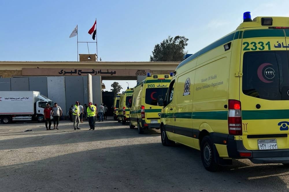 Ambulances queue at the Egyptian side of the border with the Gaza Strip in Rafah, on November 1, 2023, before entering to transport wounded to Egyptian field hospitals. - Photo by AFP