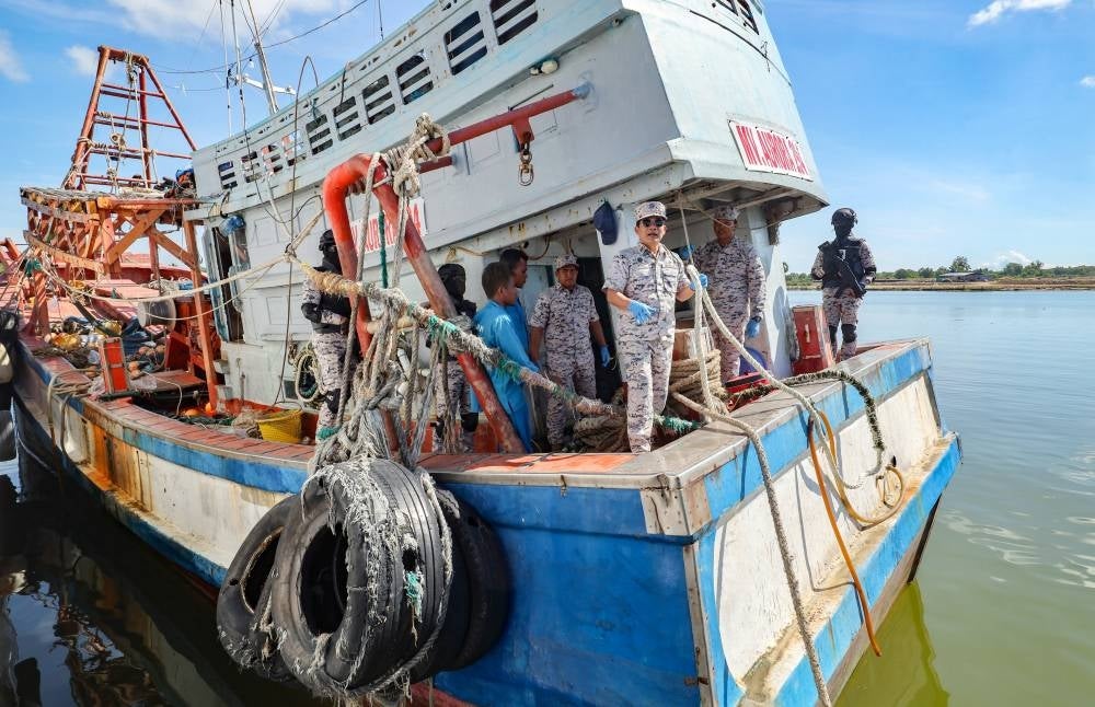 Kelantan MMEA director maritime captain Syed Nor Adli Syed Abdul Rahman (centre) with other personnel inspecting the foreign vessel in the Op Damai Khas Kuda Laut and Op Naga Barat on Monday - BERNAMA PIX