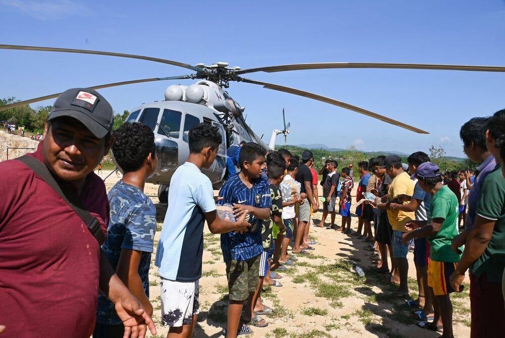 Hurricane Otis victims from different towns belonging to the municipality of Acapulco receive aid transported by air by the Mexican Navy in Acapulco, state of Guerrero, Mexico, on Nov 2. (Photo by FRANCISCO ROBLES / AFP)