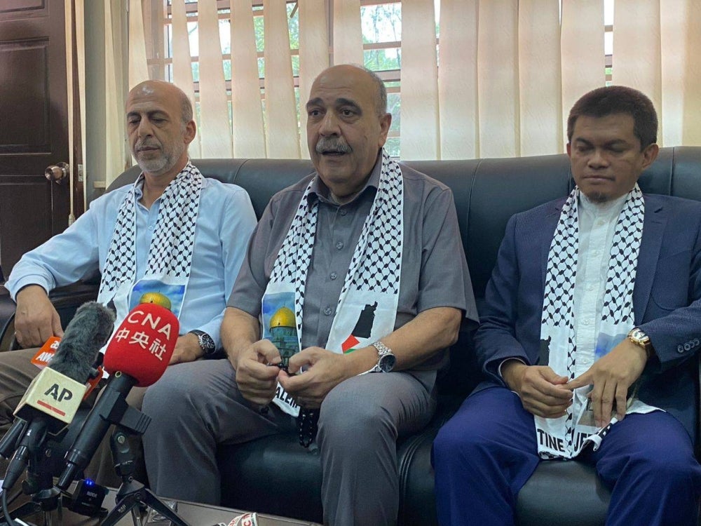 Walid Abuali (centre) during a press conference at the