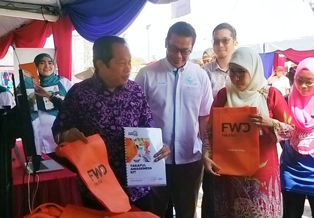 Ahmad (left) inaugurated the Kampung Masuk Takaful Programme at Dewan Homestay Kampung Puteri Menangis, Ayer Baloi, today