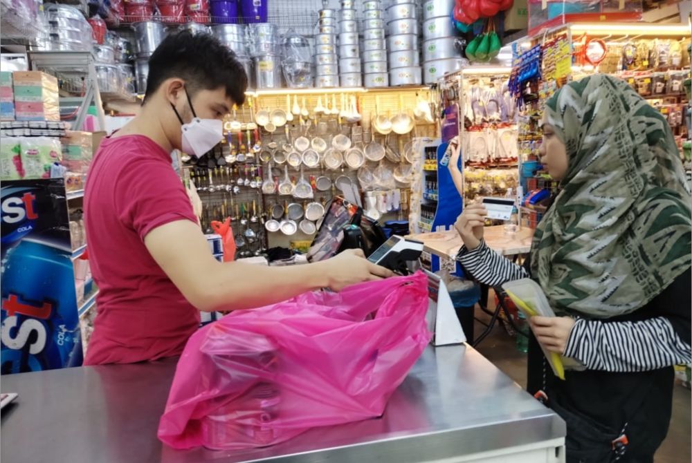 Rocky scanning an item purchased by a customer at his premises.