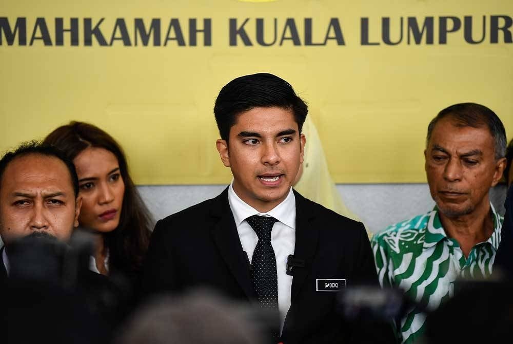 Syed Saddiq (centre) during a press conference at the Kuala Lumpur Courts Complex, yesterday. - Photo by Bernama