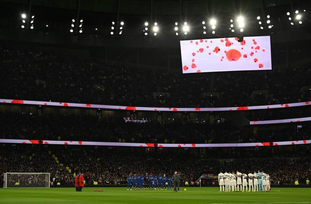 Players observe a minute's silence for Remembrance Day ahead of the English Premier League football match between Tottenham Hotspur and Chelsea at Tottenham Hotspur Stadium in London, on Nov 6. - Photo by AFP