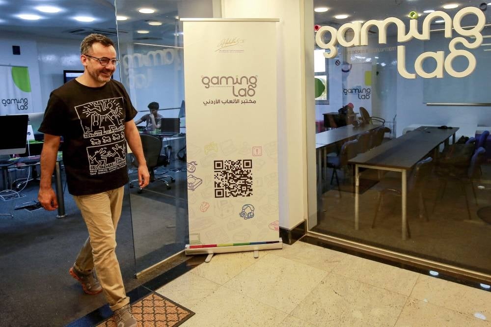 Nour Khrais, technical partner in The Jordan Gaming Lab and founder of the first mobile games development studio Maysalward, walks into his office in Amman on Sept 20, 2023. (Photo by Khalil MAZRAAWI / AFP)