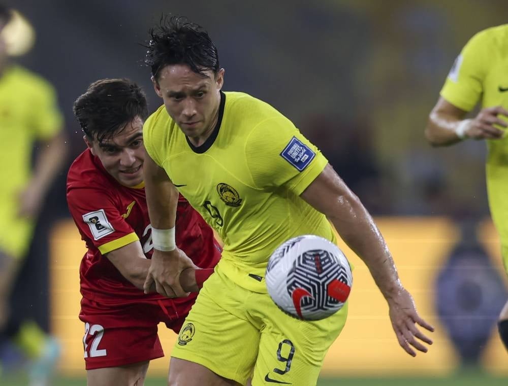 Malaysian player Darren Lok (right) tackled by Kyrgyzstan player Shukurov Alimardon (left) during the World Cup 2026 and Asia Cup 2027 Qualification Group D match between Malaysia and Kyrgyzstan at the National Stadium Bukit Jalil tonight. (BERNAMA PHOTO)
