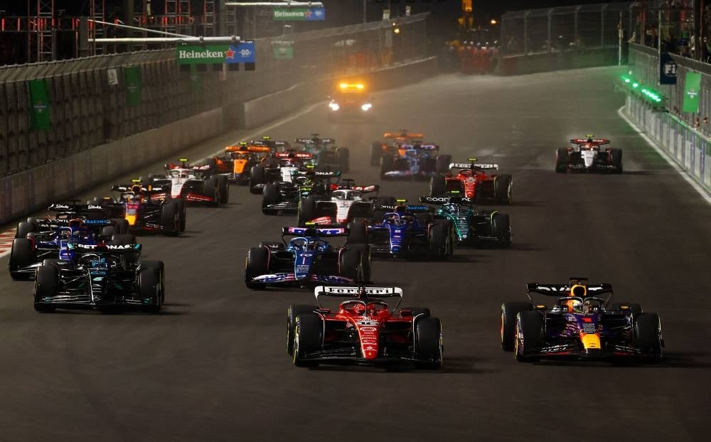 Max Verstappen of the Netherlands driving the (1) Oracle Red Bull Racing RB19 leads Charles Leclerc of Monaco driving the (16) Ferrari SF-23 at turn one during the F1 Grand Prix of Las Vegas at Las Vegas Strip Circuit on November 18, 2023 in Las Vegas, Nevada. (Photo by Mark Thompson / AFP)