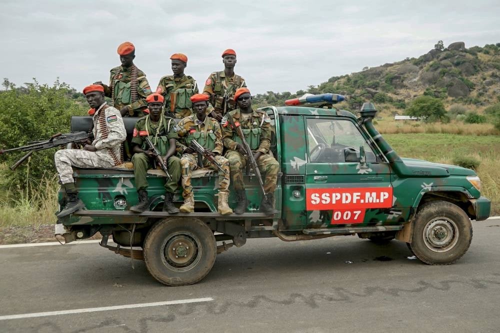 South Sudanese military police officers sit on a pickup truck as they monitor the area during a South Sudanese Unified Forces deployment ceremony at the Luri Military Training Centre in Juba on November 15, 2023 - AFP 