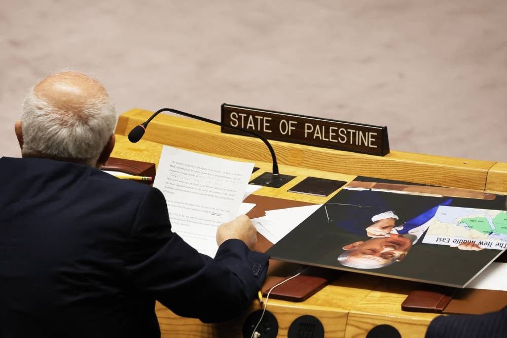 A photo of Israeli Prime Minister Benjamin Netanyahu sits on a table as Permanent Observer of Palestine to the United Nations Riyad H. Mansour speaks during a UN Security Council meeting on the situation in the Middle East and the Israel-Hamas war at the United Nations headquarters on Nov 22, 2023 in New York City. - AFP